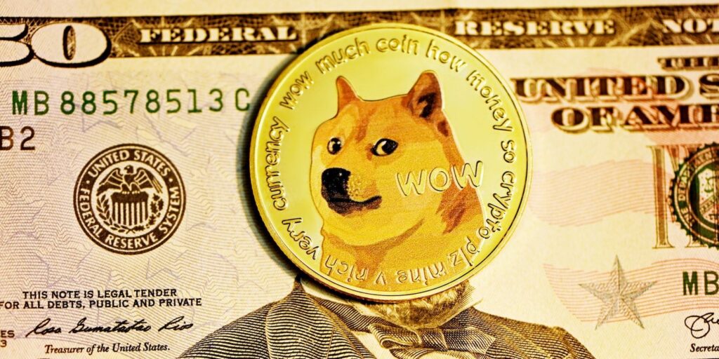 A doge coin on top of 50 dollar american bill.