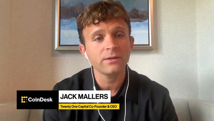 no_translation_1157_ffhaj7cer7v0iim75vzkfy4c_no_translation_translation - Crypto and Coin Video interview scene with a man in a black shirt wearing white earbuds; lower third shows CoinDesk, 'JACK MALLERS', and 'Twenty One Capital Co-Founder & CEO'.
