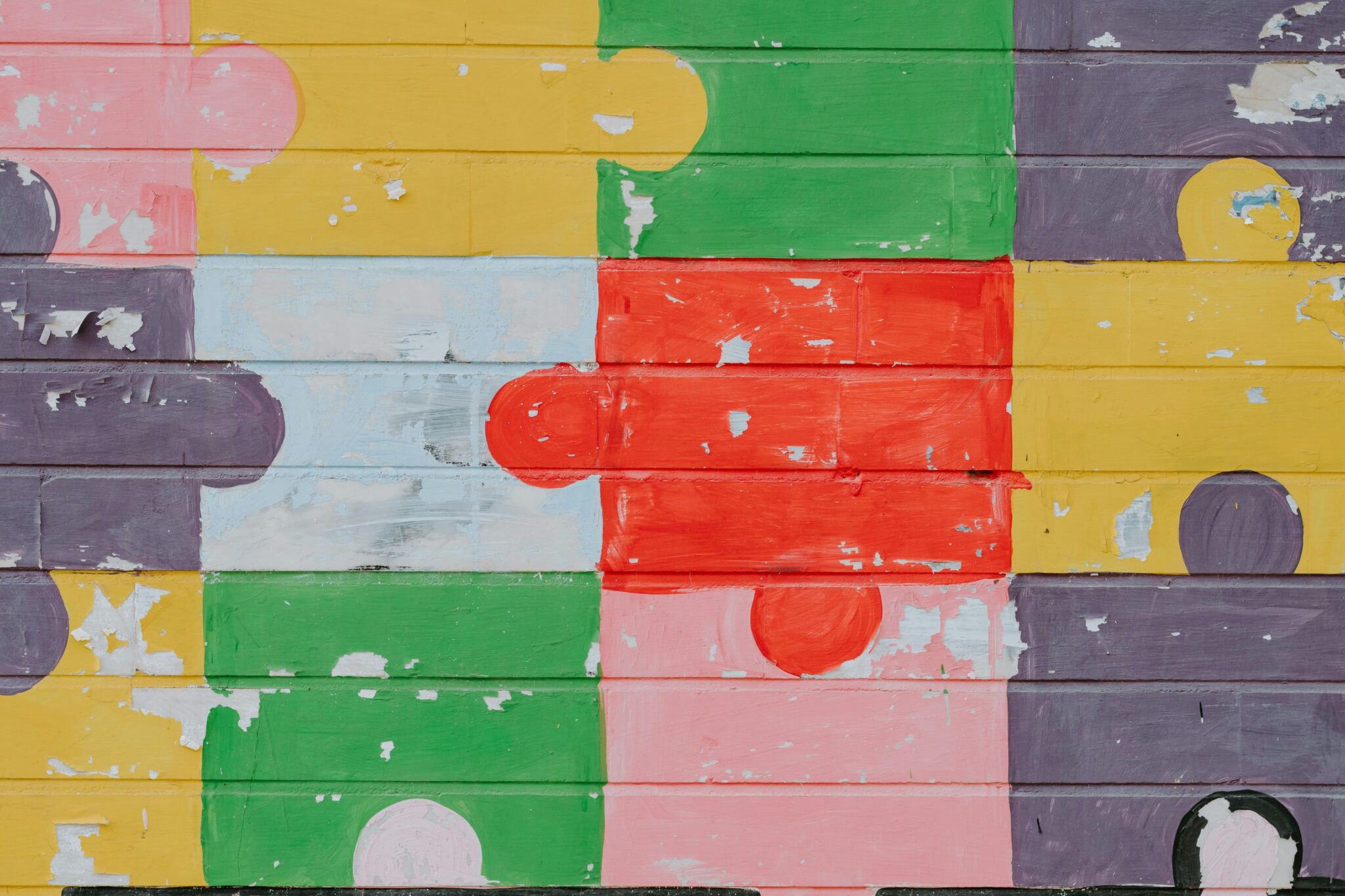 no_translation_2297_ffhaj7cer7v0iim75vzkfy4c_no_translation_translation - Crypto and Coin Abstract colorful mural on wooden planks with stacked blocks of pink, yellow, green, purple and red, showing peeling paint and wear.